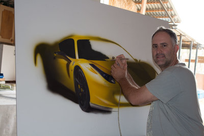 Artist Ronen Zlotogoura working on hyperrealistic painting of Ferrari.jpg